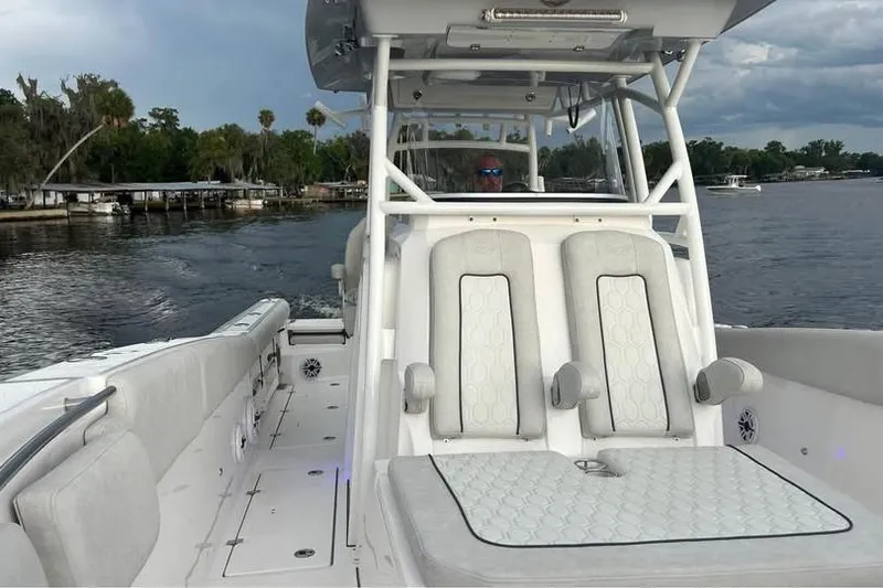 Slide: The Image of 2023 Sea Fox 328 Commander boat on a calm lake with lush shoreline. - 10