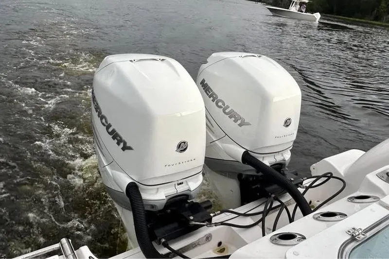 Slide: The Image of Twin Mercury outboard engines on a 2023 Sea Fox 328 Commander boat in water. - 11