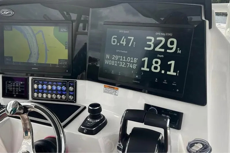 Slide: The Image of 2023 Sea Fox 328 Commander dashboard with GPS navigation and control systems. - 13