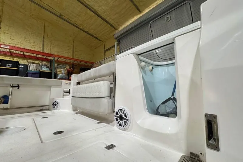 Slide: The Image of 2023 Sea Fox 328 Commander interior with seating and storage in a warehouse setting. - 7