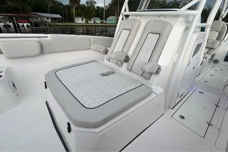 Slide: The Image of 2023 Sea Fox 328 Commander boat interior with cushioned seating and sleek design. - 9