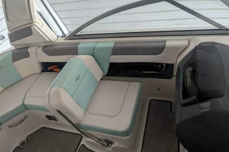 Slide: The Image of 2021 Chaparral 230 Suncoast boat interior with teal and gray seating. - 10