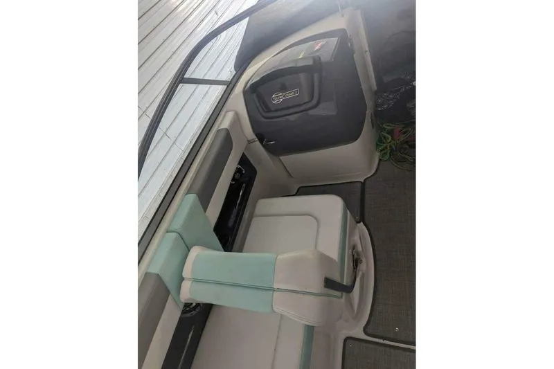 Slide: The Image of 2021 Chaparral 230 Suncoast boat interior with seating and storage compartment. - 16