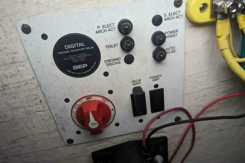 Slide: The Image of Control panel of a 2021 Chaparral 230 Suncoast boat with switches and wiring. - 19