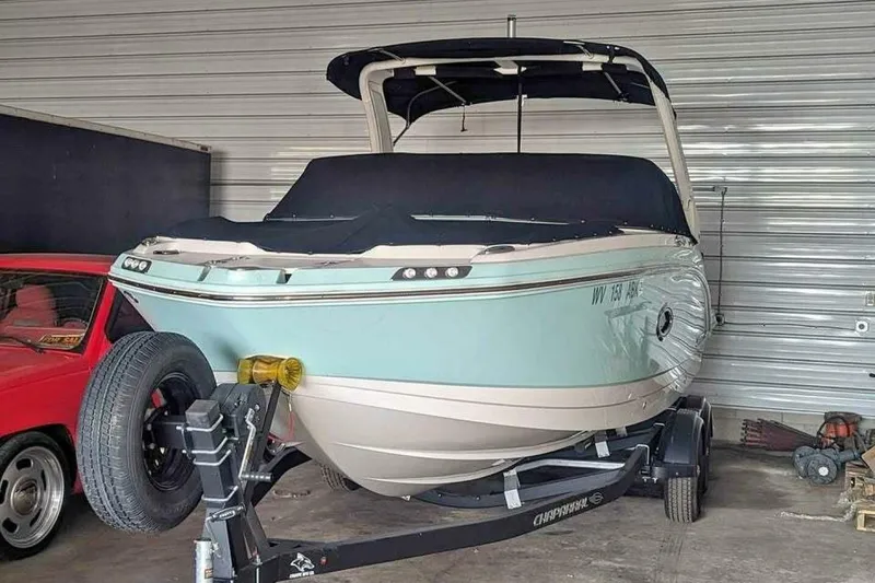 Slide: The Image of 2021 Chaparral 230 Suncoast boat on trailer in storage garage. - 3