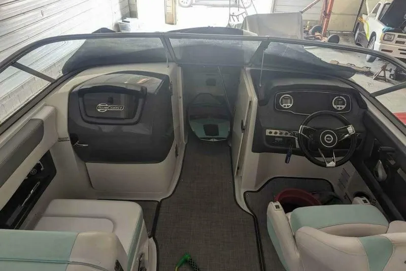 Slide: The Image of 2021 Chaparral 230 Suncoast boat interior with steering wheel and seating. - 7