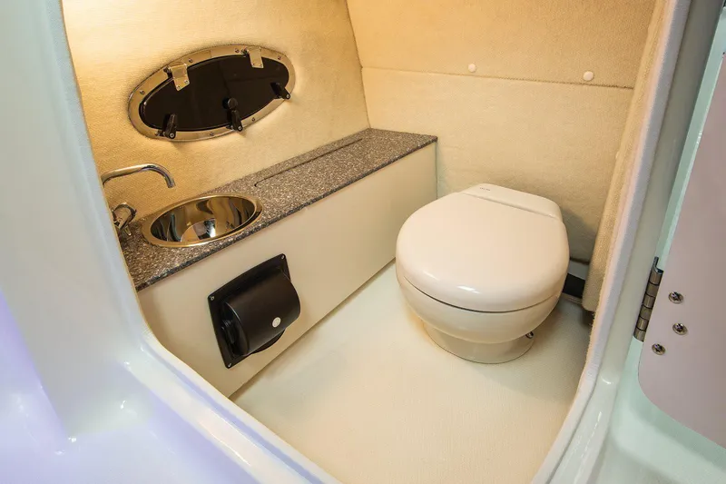 Slide: The Image of Manufacturer Provided Image: 2021 Chaparral 230 Suncoast boat interior bathroom with sink and toilet. - 8