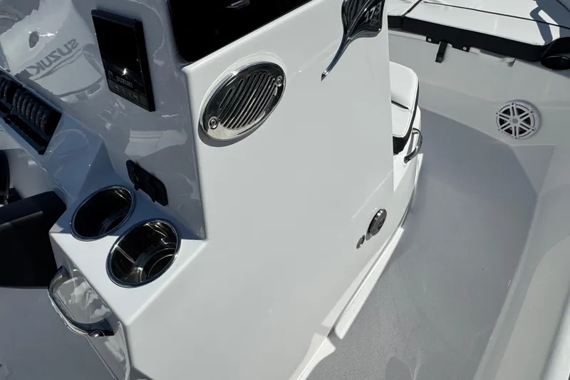 Slide: The Image of 2026 Stingray 173 CC boat interior with cup holders and control panel. - 12