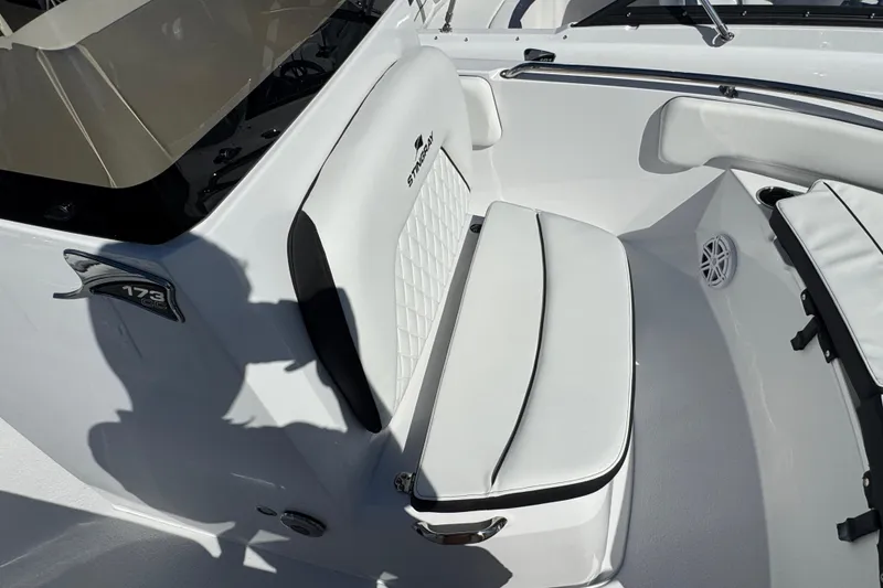 Slide: The Image of 2026 Stingray 173 CC boat interior with white seating and logo detail. - 14