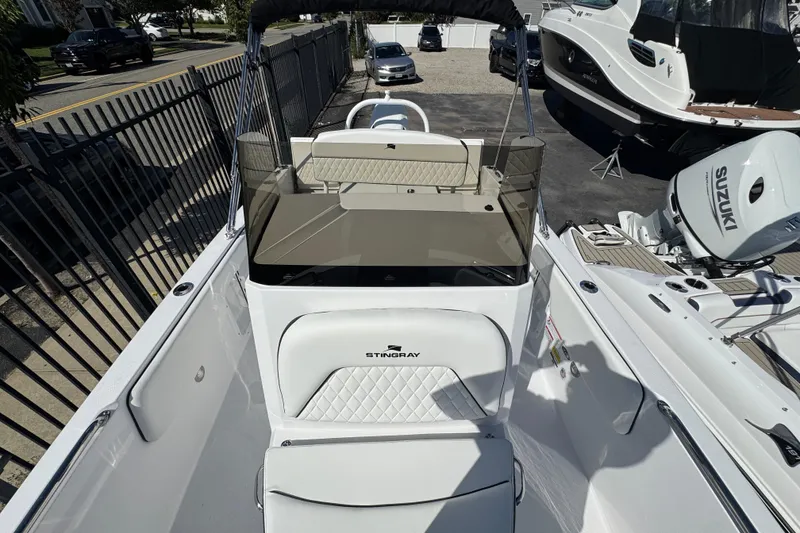 Slide: The Image of 2026 Stingray 173 CC boat with Suzuki outboard motor, parked outdoors. - 17