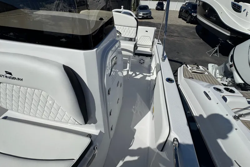 Slide: The Image of 2026 Stingray 173 CC boat interior with white seating and sleek design. - 18