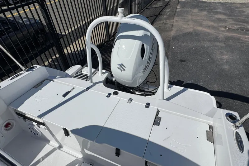 Slide: The Image of 2026 Stingray 173 CC boat with Suzuki outboard motor, docked near a fence. - 3