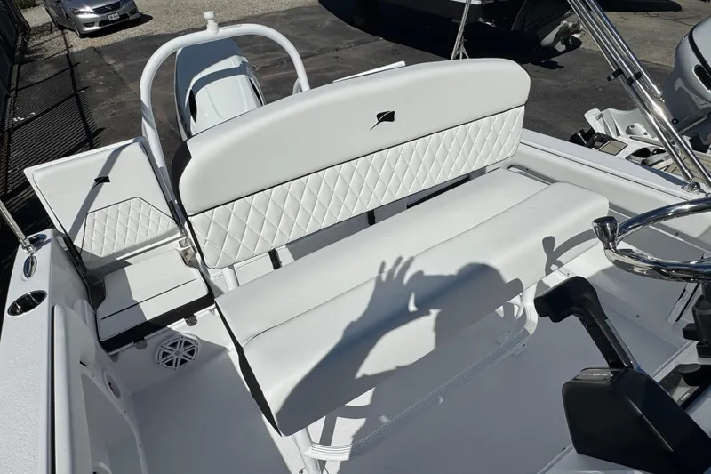 Slide: The Image of 2026 Stingray 173 CC boat interior with white seating and steering wheel. - 7