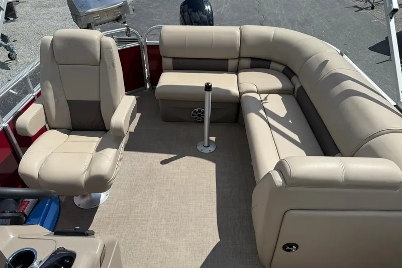 Slide: The Image of 2023 Sun Tracker Party Barge 20 DLX interior with beige seating and spacious layout. - 10