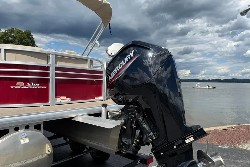 Slide: The Image of 2023 Sun Tracker Party Barge 20 DLX with Mercury outboard motor by a lake. - 3
