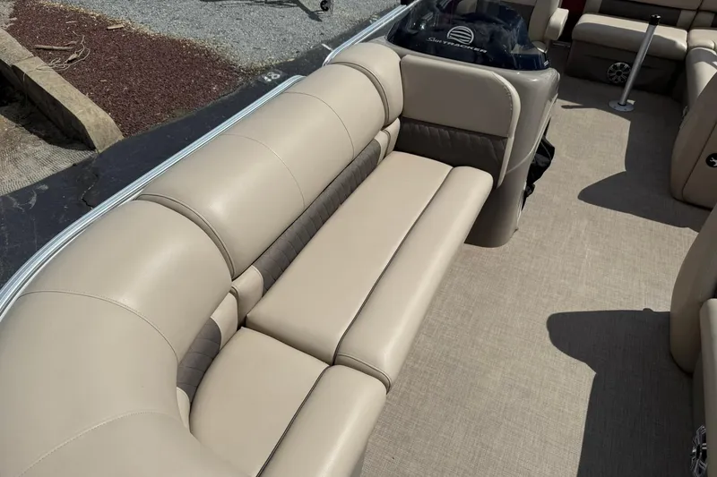 Slide: The Image of 2023 Sun Tracker Party Barge 20 DLX with beige seating and spacious interior. - 9
