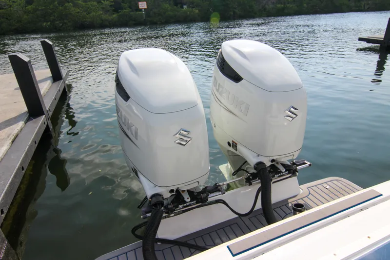 Slide: The Image of Twin Suzuki outboard engines on a 1996 Ocean Master 31 Center Console boat. - 14