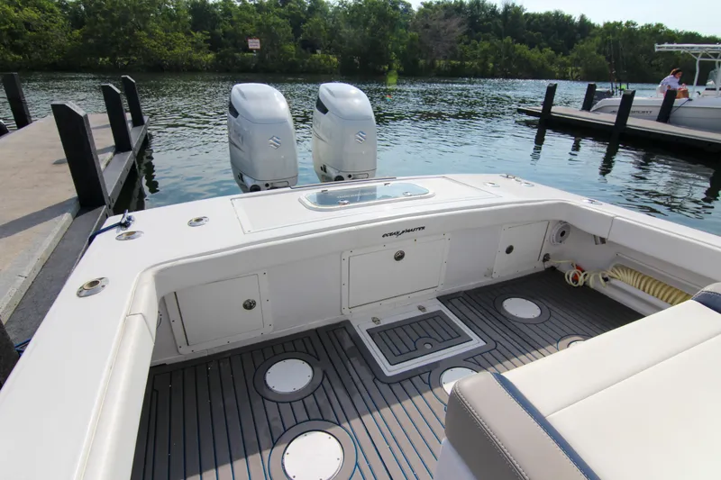 Slide: The Image of 1996 Ocean Master 31 Center Console boat with dual engines docked by the water. - 16