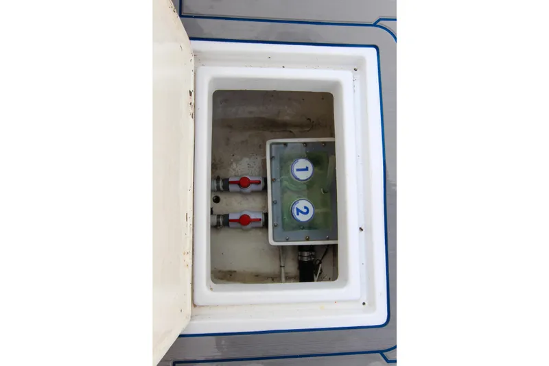 Slide: The Image of Hatch interior of 1996 Ocean Master 31 Center Console with numbered valves. - 19