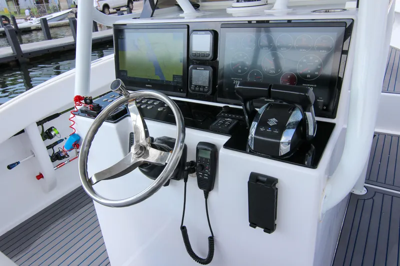 Slide: The Image of 1996 Ocean Master 31 Center Console helm with modern navigation and control systems. - 2