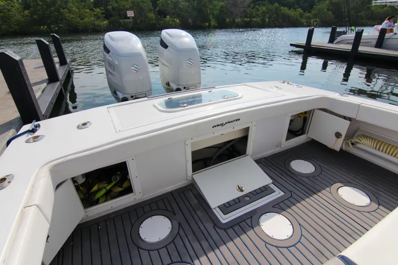 Slide: The Image of 1996 Ocean Master 31 Center Console boat with twin outboard engines docked by the water. - 20