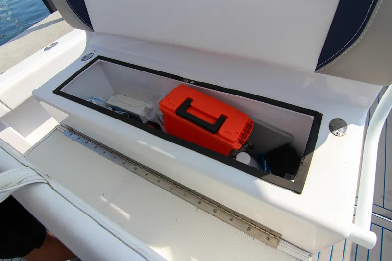 Slide: The Image of Storage compartment on a 1996 Ocean Master 31 Center Console boat with orange case. - 21