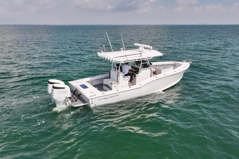 Slide: The Image of 1996 Ocean Master 31 Center Console boat cruising on open water. - 25