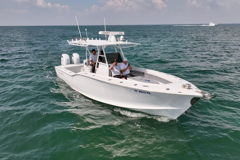 Slide: The Image of 1996 Ocean Master 31 Center Console boat cruising on open water. - 27