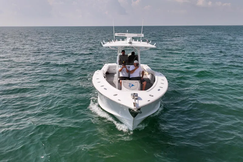 Slide: The Image of 1996 Ocean Master 31 Center Console boat cruising on open water. - 28