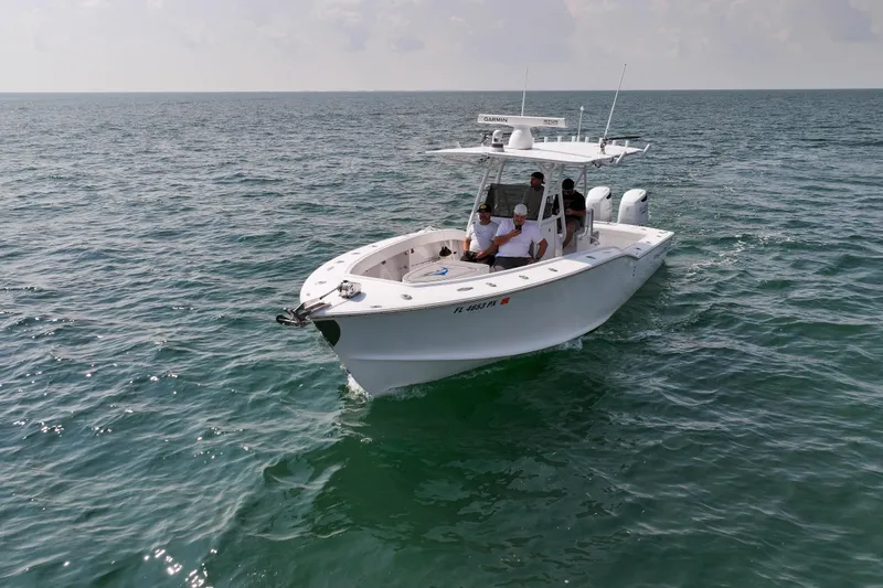 Slide: The Image of 1996 Ocean Master 31 Center Console boat cruising on open water. - 29