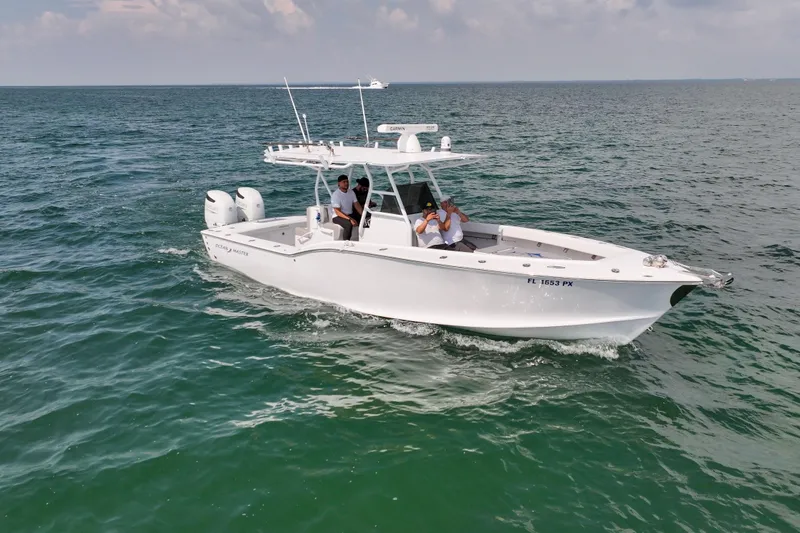 Slide: The Image of 1996 Ocean Master 31 Center Console boat cruising on open water. - 30