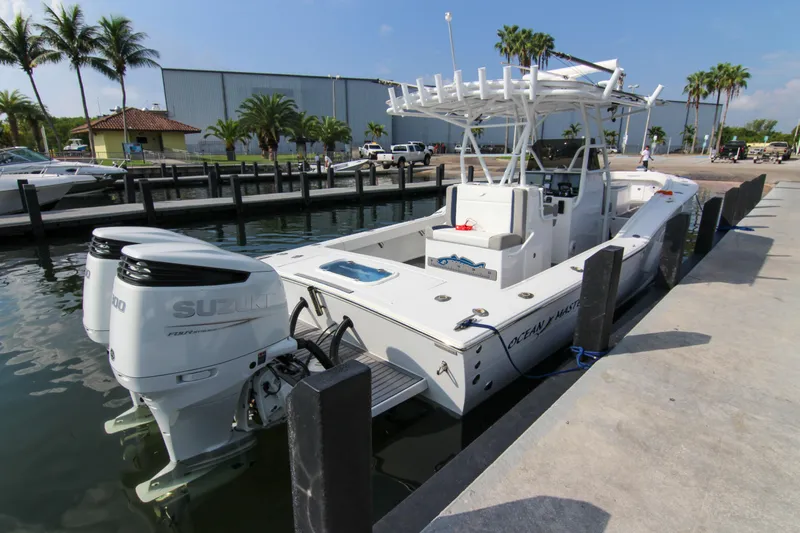 Slide: The Image of 1996 Ocean Master 31 Center Console boat docked with twin Suzuki engines. - 5