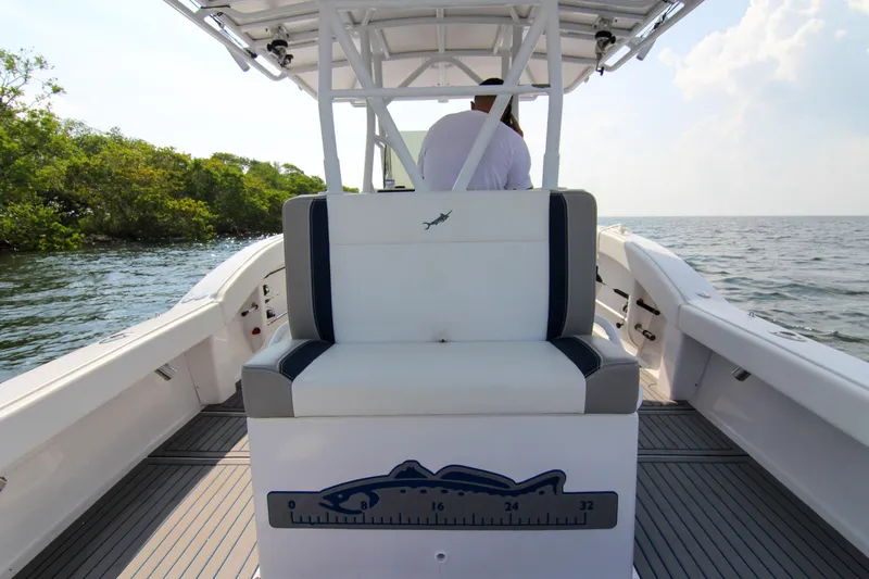Slide: The Image of 1996 Ocean Master 31 Center Console boat on open water, featuring sleek seating and modern design. - 9