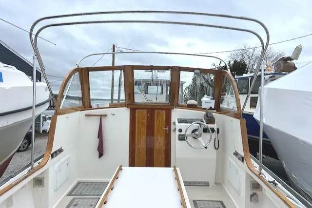 Slide: The Image of 2001 Duffy 26 boat interior with wooden accents and steering wheel. - 10