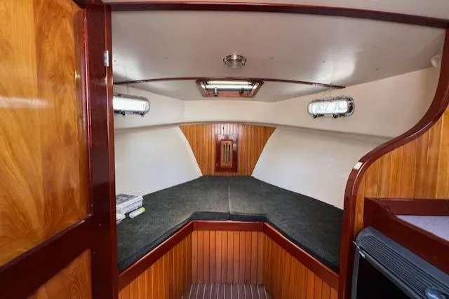 Slide: The Image of Interior cabin of 2001 Duffy 26 boat with wood paneling and skylight. - 13