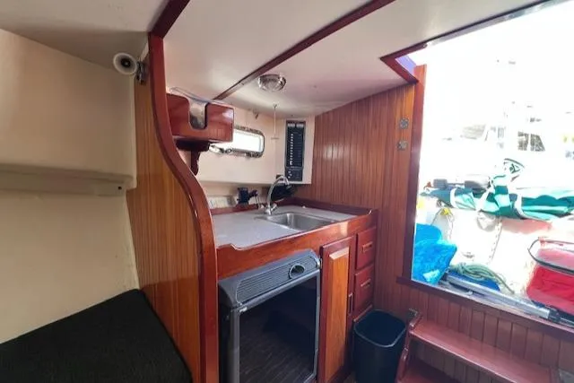 Slide: The Image of Interior of 2001 Duffy 26 boat with kitchenette and wooden paneling. - 15