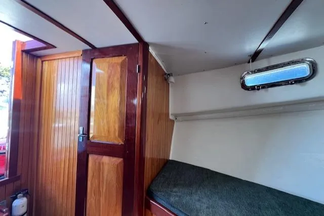 Slide: The Image of Interior cabin of a 2001 Duffy 26 boat with wooden door and small window. - 16