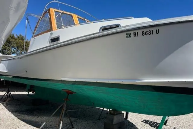 Slide: The Image of 2001 Duffy 26 boat on stands, white hull, green bottom, clear blue sky. - 20