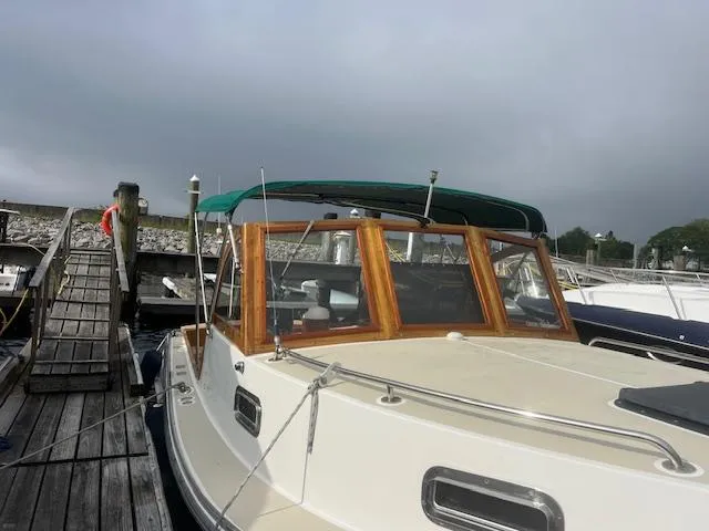 Slide: The Image of 2001 Duffy 26 boat docked at a marina under cloudy skies. - 21
