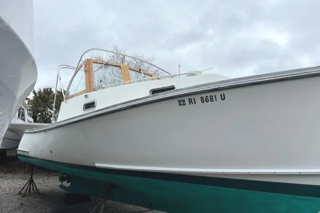 Slide: The Image of 2001 Duffy 26 boat with registration RI 8681 U, docked on land. - 6