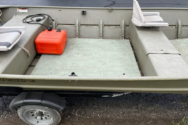 Slide: The Image of 2008 Crestliner CR 1648 boat interior with seats and red fuel tank. - 10