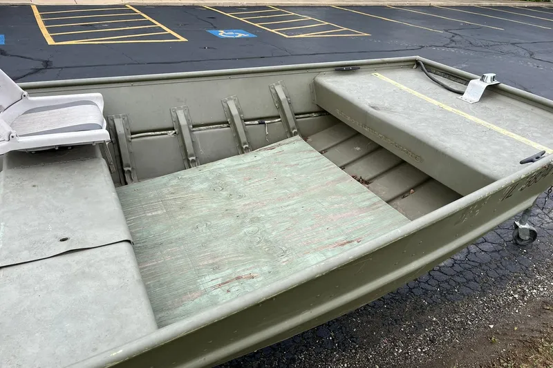 Slide: The Image of 2008 Crestliner CR 1648 boat with seating, parked in a lot. - 11