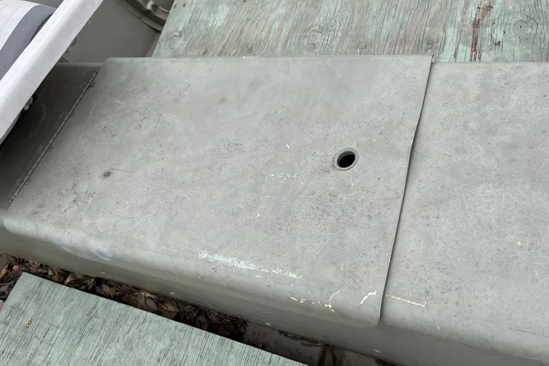 Slide: The Image of 2008 Crestliner CR 1648 boat deck with a small drainage hole. - 12