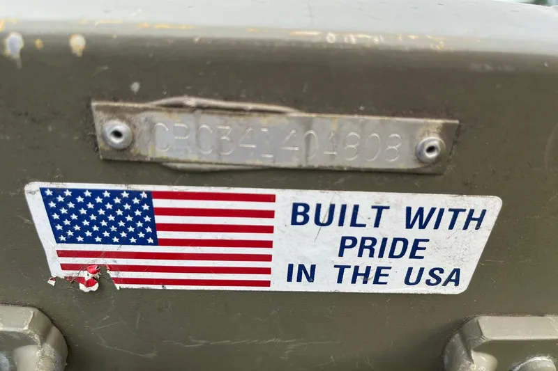 Slide: The Image of 2008 Crestliner CR 1648 boat with "Built with Pride in the USA" sticker and serial number. - 13