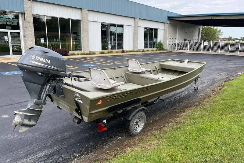 Slide: The Image of 2008 Crestliner CR 1648 boat with Yamaha motor parked outside a sales building. - 4