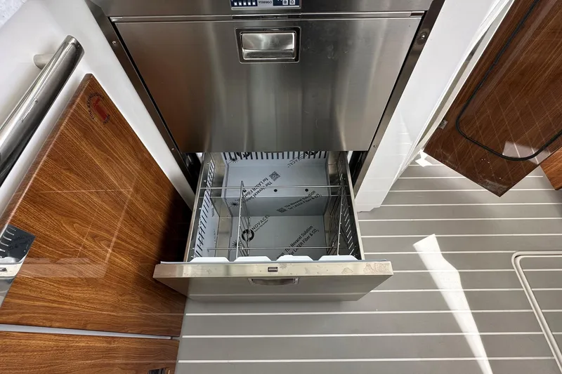 Slide: The Image of Open drawer in 2026 Tiara Yachts 48 LS, showcasing modern stainless steel interior. - 15