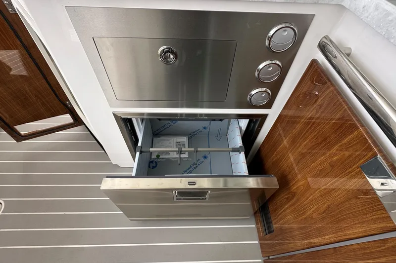 Slide: The Image of 2026 Tiara Yachts 48 LS interior with stainless steel drawer and wooden accents. - 17