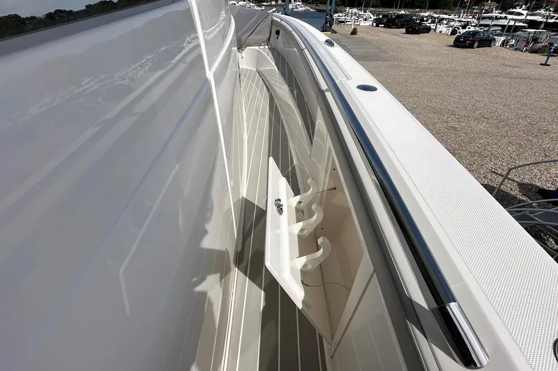 Slide: The Image of 2026 Tiara Yachts 48 LS side deck view with sleek design and railing. - 18