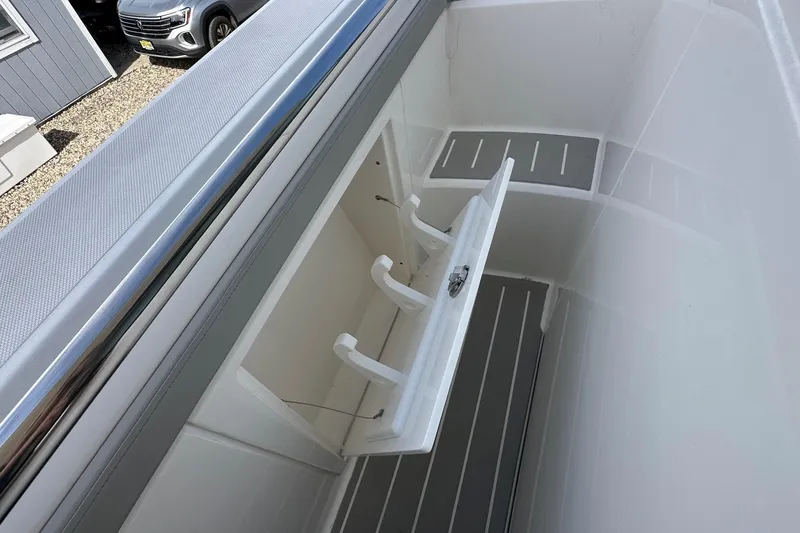 Slide: The Image of 2026 Tiara Yachts 48 LS storage compartment with open hatch, showcasing sleek design. - 20