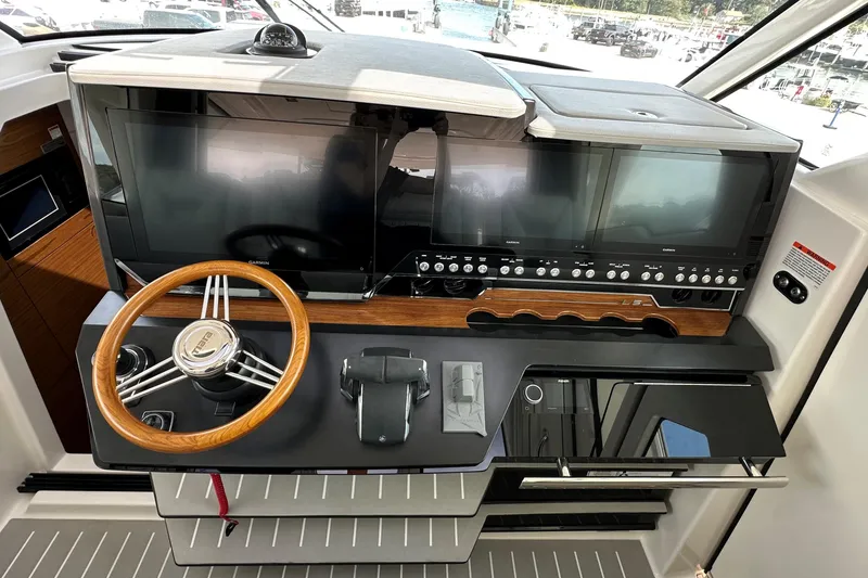 Slide: The Image of Helm of 2026 Tiara Yachts 48 LS featuring advanced navigation displays and controls. - 24